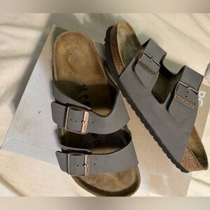 Birkenstock Arizonas in light grey.